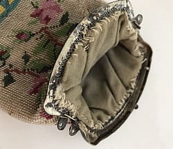 inside of a well worn 1800’s coin purse with  sterling frame